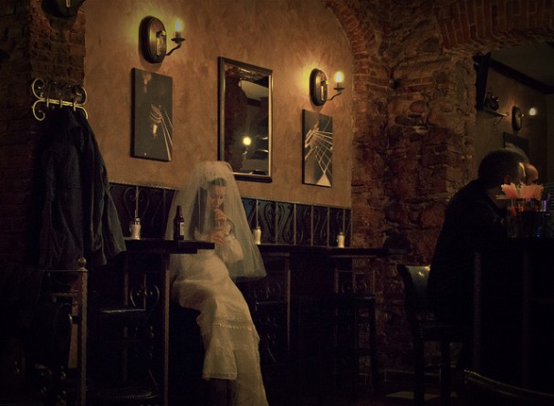 Bride drinking alone in the bar