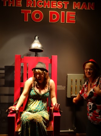 girl pretending to be electrocuted in chair in mob museum las vegas