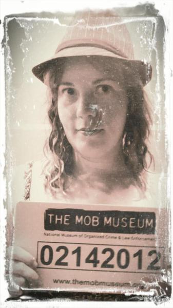 girl posing for fake mug shot from mob museum las vegas