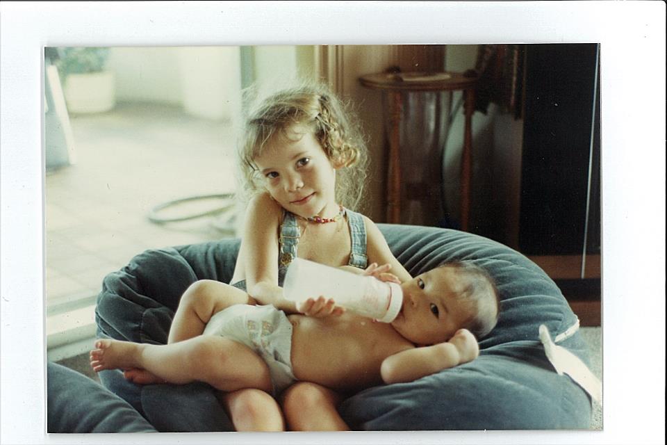Reannon at the age of three, holding baby brother