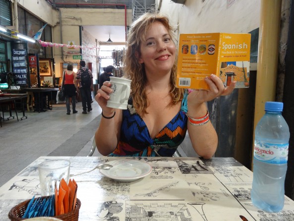 reannon in buenos aires argentina reannon sipping coffee and reading a Spanish language phrase book in buenos aires