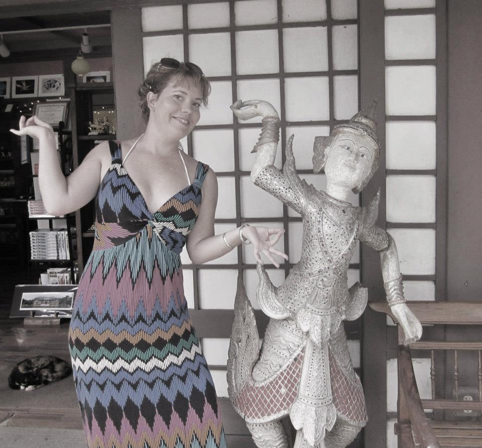 Reannon posing next to Buddhist statue at Temple Valley on Oahu in Hawaii