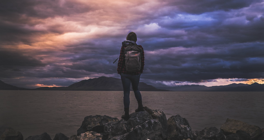 Backpacker looking at lake